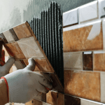 The man who is doing tiling