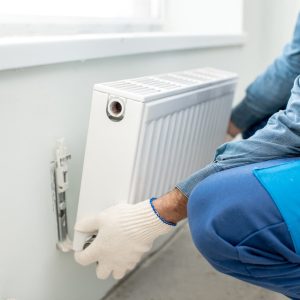 A man installing a radiator