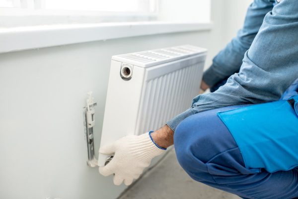 A man installing a radiator